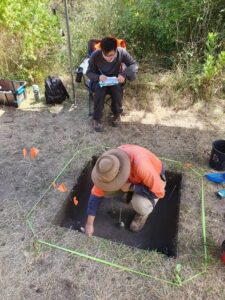 Dr Ben Shaw working in a dig.