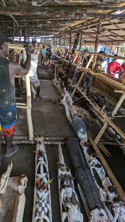 Interior of an Asmat longhouse under construction in Papua, Indonesia